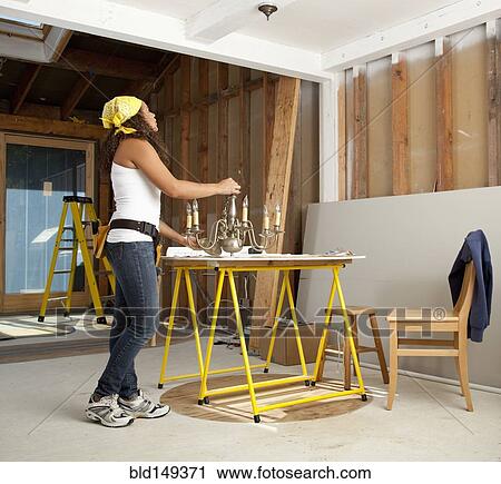 Hispanic woman holding light fixture View Large Photo Image Stock Image - Hispanic woman holding light fixture. Fotosearch