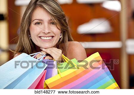 Hispanic woman holding shopping bags View Large Photo Image Stock Photo - Hispanic woman holding shopping bags. Fotosearch