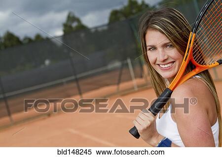 Hispanic woman holding tennis racquet on court View Large Photo Image Stock Photography - Hispanic woman holding tennis racquet on court. Fotosearch