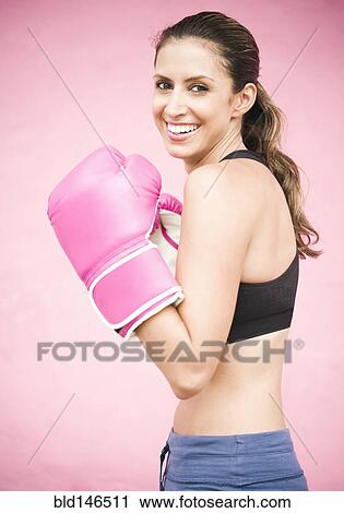 Stock Image - Hispanic woman in boxing gloves. Fotosearch