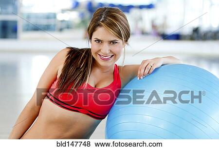 Hispanic woman leaning on exercise ball View Large Photo Image Stock Photo - Hispanic woman leaning on exercise ball. Fotosearch