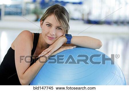 Hispanic woman leaning on exercise ball View Large Photo Image Stock Photography - Hispanic woman leaning on exercise ball. Fotosearch