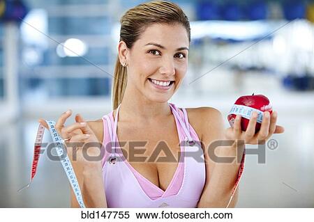 Hispanic woman measuring apple View Large Photo Image Stock Photography - Hispanic woman measuring apple. Fotosearch