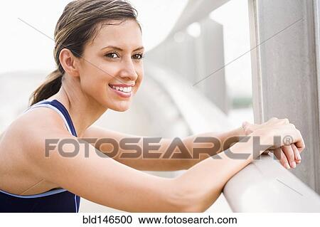 Stock Image - Hispanic woman resting after exercise. Fotosearch