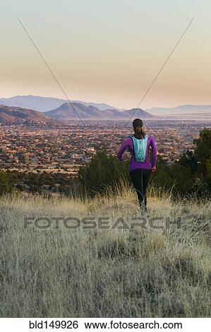 Stock Photograph - Hispanic woman running in remote area. Fotosearch