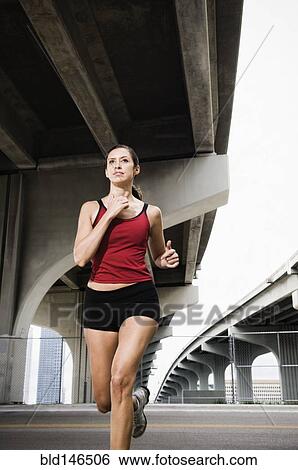 Hispanic woman running in urban area View Large Photo Image Stock Photograph - Hispanic woman running in urban area. Fotosearch