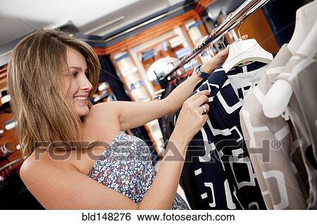 Stock Photograph - Hispanic woman shopping in store. Fotosearch