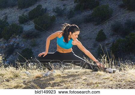 Hispanic woman stretching before exercise View Large Photo Image Stock Image - Hispanic woman stretching before exercise. Fotosearch