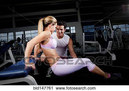 Hispanic woman working with personal trainer in health club View Large Photo Image Stock Image - Hispanic woman working with personal trainer in health club. Fotosearch
