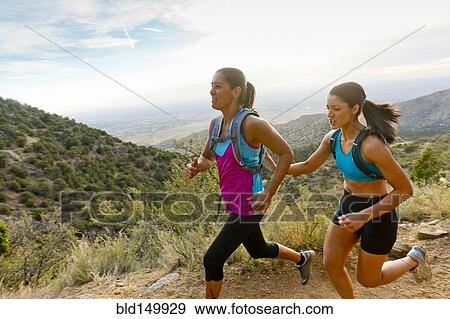 Stock Photo - Hispanic women running in remote area. Fotosearch