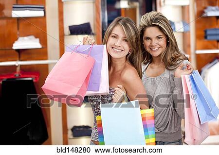 Stock Image - Hispanic women shopping together. Fotosearch