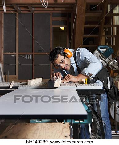 Hispanic worker using table saw View Large Photo Image Stock Photo - Hispanic worker using table saw. Fotosearch