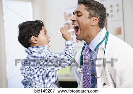 Indian boy examining doctor in doctor's office View Large Photo Image Stock Photo - Indian boy examining doctor in doctor's office. Fotosearch