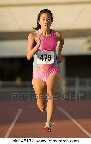 Stock Image - Japanese runner competing on racetrack. Fotosearch