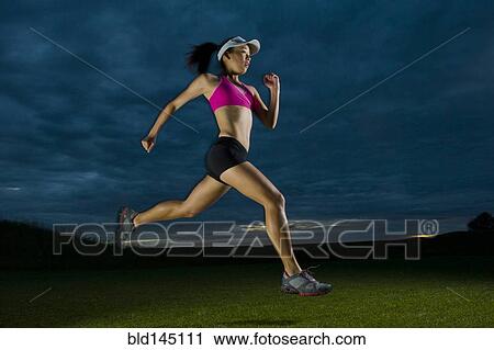 Japanese woman running at night View Large Photo Image Stock Image - Japanese woman running at night. Fotosearch