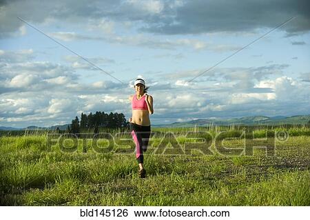 Japanese woman running in field View Large Photo Image Stock Photograph - Japanese woman running in field. Fotosearch