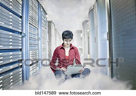 Stock Photo - Kazakhstan businesswoman working on laptop in server room. Fotosearch