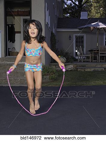 Korean girl jumping rope in driveway View Large Photo Image Stock Image - Korean girl jumping rope in driveway. Fotosearch