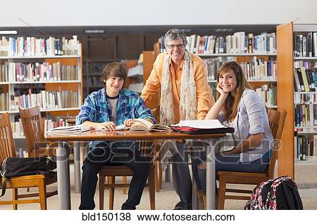 Librarian with students in library View Large Photo Image Stock Photo - Librarian with students in library. Fotosearch
