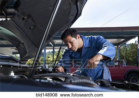 Middle Eastern mechanic working on car engine View Large Photo Image Stock Photo - Middle Eastern mechanic working on car engine. Fotosearch
