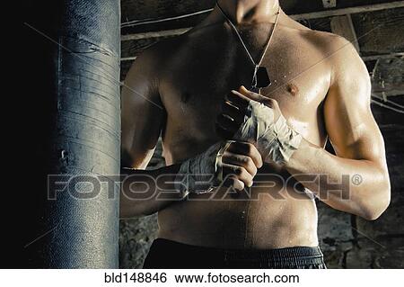 Stock Photograph - Midsection of Caucasian fighter with taped hands. Fotosearch