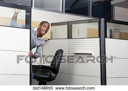 Mixed race businessman peering out from office cubicle View Large Photo Image Stock Photography - Mixed race businessman peering out from office cubicle. Fotosearch