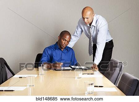 Mixed race businessmen working together in conference room View Large Photo Image Stock Photography - Mixed race businessmen working together in conference room. Fotosearch