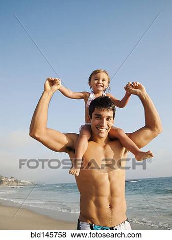 Mixed race father carrying daughter on shoulders View Large Photo Image Stock Photo - Mixed race father carrying daughter on shoulders. Fotosearch