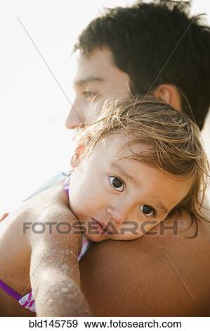 Mixed race father comforting daughter View Large Photo Image Stock Photo - Mixed race father comforting daughter. Fotosearch