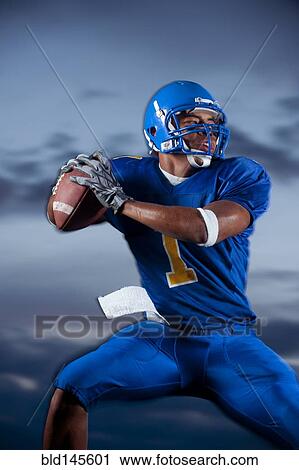 Mixed race football player preparing to throw football View Large Photo Image Stock Image - Mixed race football player preparing to throw football. Fotosearch