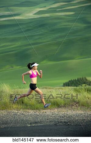 Mixed race runner running in countryside View Large Photo Image Stock Photo - Mixed race runner running in countryside. Fotosearch