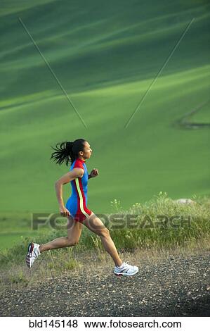 Mixed race runner running in countryside View Large Photo Image Stock Photo - Mixed race runner running in countryside. Fotosearch