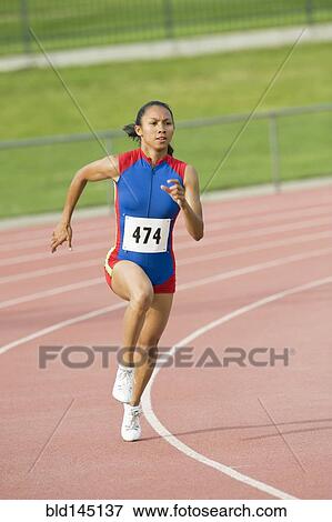 Mixed race runner running on racetrack View Large Photo Image Stock Photo - Mixed race runner running on racetrack. Fotosearch