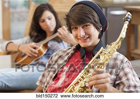 Mixed race teenagers playing musical instruments View Large Photo Image Stock Image - Mixed race teenagers playing musical instruments. Fotosearch
