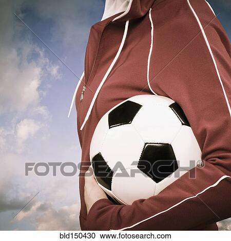 Mixed race woman carrying soccer ball View Large Photo Image Stock Image - Mixed race woman carrying soccer ball. Fotosearch