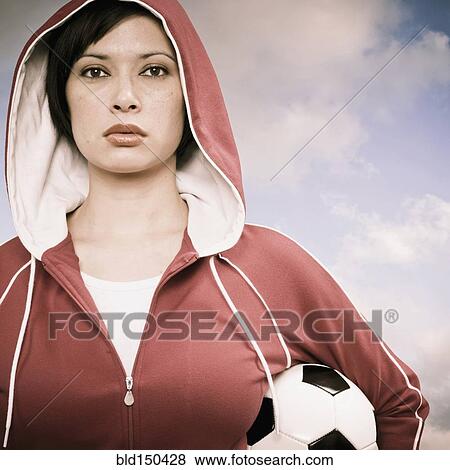 Mixed race woman carrying soccer ball View Large Photo Image Stock Photo - Mixed race woman carrying soccer ball. Fotosearch