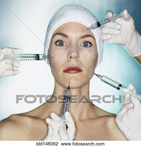 Stock Image - Mixed race woman having facial injections. Fotosearch