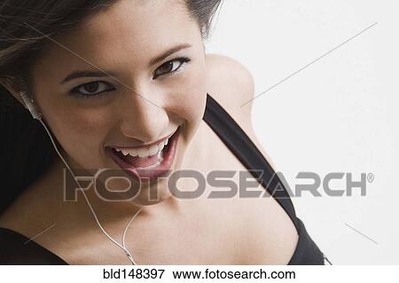 Mixed race woman listening to headphones and singing View Large Photo Image Stock Photo - Mixed race woman listening to headphones and singing. Fotosearch