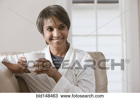 Stock Image - Native American woman drinking coffee. Fotosearch
