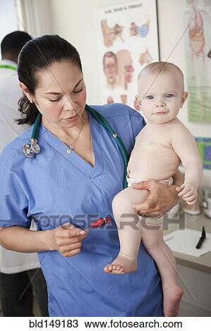 Nurse checking baby's reflexes in doctor's office View Large Photo Image Stock Image - Nurse checking baby's reflexes in doctor's office. Fotosearch