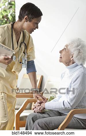 Nurse talking to elderly woman View Large Photo Image Picture - Nurse talking to elderly woman. Fotosearch