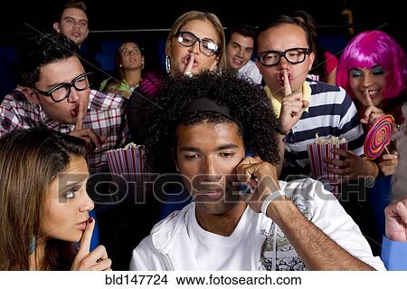 People quieting noisy person in movie theater View Large Photo Image Picture - People quieting noisy person in movie theater. Fotosearch