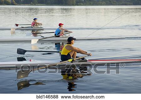 Stock Photo - People rowing sculling boats on river. Fotosearch