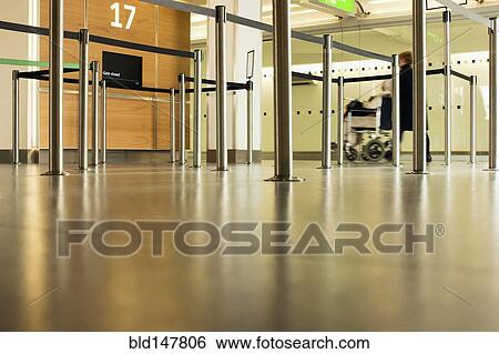Person pushing wheelchair in airport View Large Photo Image Stock Photograph - Person pushing wheelchair in airport. Fotosearch