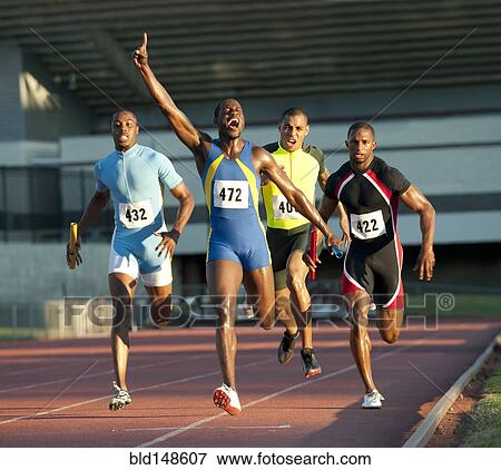 Relay racer crossing finish line on track in race View Large Photo Image Stock Photo - Relay racer crossing finish line on track in race. Fotosearch