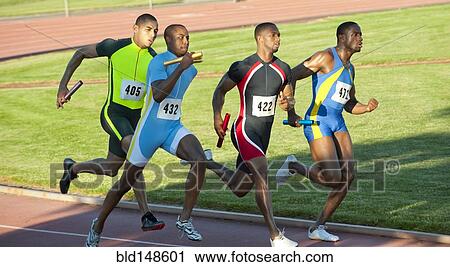Stock Image - Relay racers running on track in race. Fotosearch