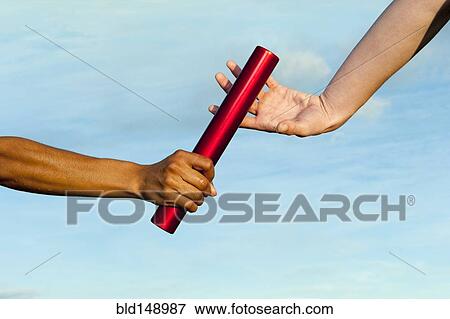 Runner passing baton to teammate View Large Photo Image Stock Photo - Runner passing baton to teammate. Fotosearch