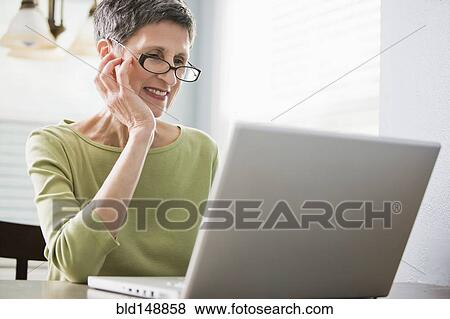 Senior woman using laptop View Large Photo Image Stock Photo - Senior woman using laptop. Fotosearch