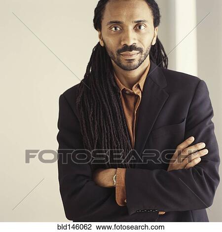 Stock Image - Serious African American businessman with arms crossed. Fotosearch