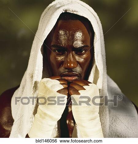 Serious boxer holding taped hands up View Large Photo Image Stock Photograph - Serious boxer holding taped hands up. Fotosearch